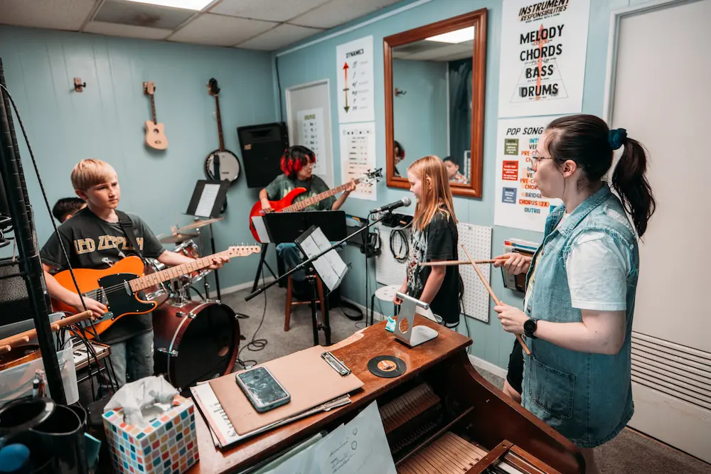Music students practicing together in a band rehearsal space